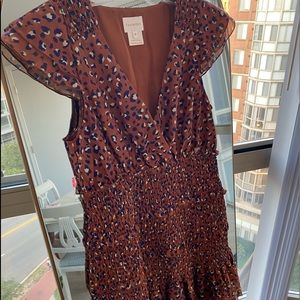 Red-brown elastic dress with butterfly sleeves and a purple/white pattern.